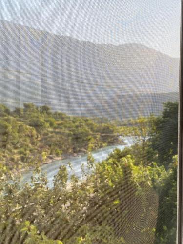 a view of a river with mountains in the background at Vacation Home Ilia in Përmet