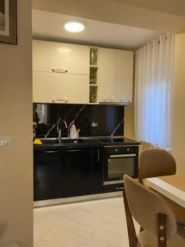 a kitchen with a sink and a stove at Vacation Home Ilia in Përmet