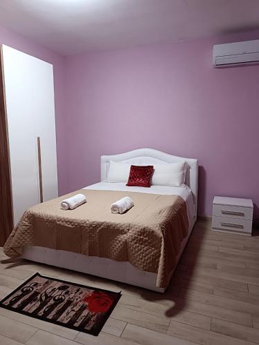 a bedroom with a bed with two pillows on it at Locazione turistica 2 in Tessera