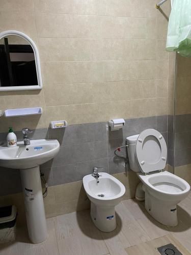 a bathroom with a toilet and a sink at Appartement a saidia de 100m2 familiale in Saidia 