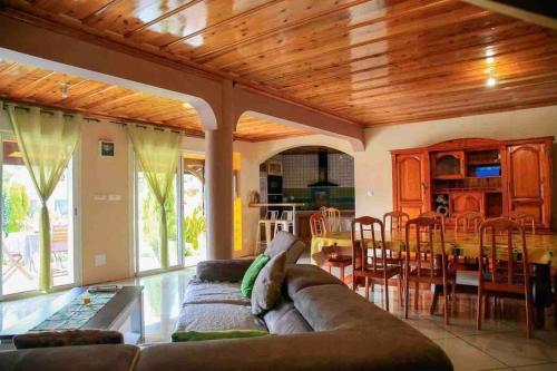 a living room with a couch and a dining room at Villa Passiflora in Cilaos