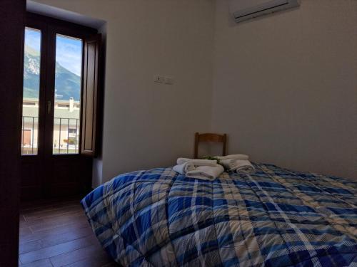 a bedroom with a bed with towels on it at Dimore Rosantò in Palombaro