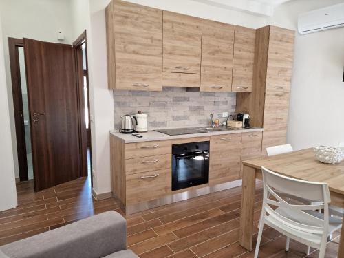 a kitchen with wooden cabinets and a wooden table at Dimore Rosantò in Palombaro