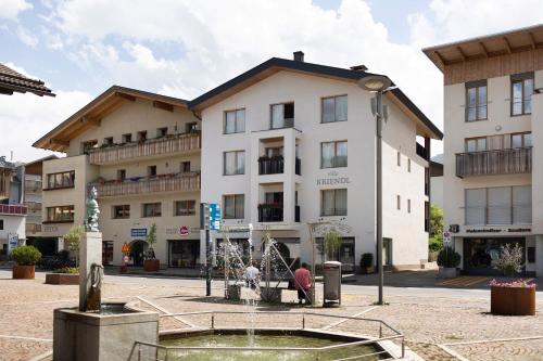 a large building with a fountain in front of it at Kriendl Nr 1 in Valdaora