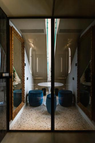 a mirror reflection of a table in a room at Palazzetto MyVenice in Venice