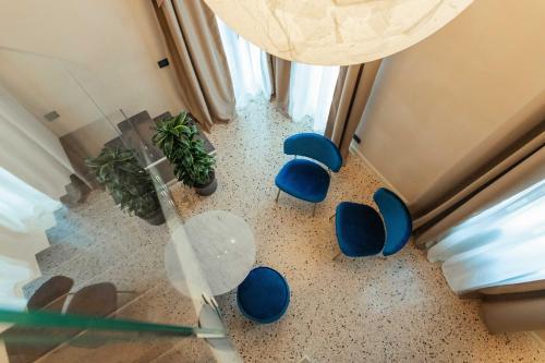 a room with blue chairs and a table and a window at Palazzetto MyVenice in Venice