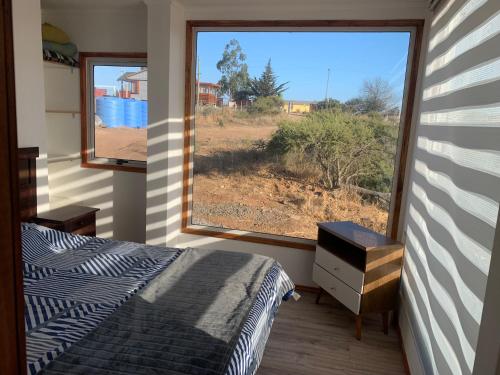 a bedroom with a bed and a large window at Casa en parcela in El Convento