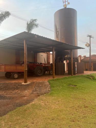 a truck parked under a building with a silo at Status Motel Ourinhos in Ourinhos