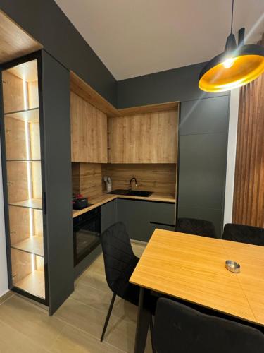 a kitchen and dining room with a table and chairs at Aral Apartments - Shengjin City Gate in Shëngjin