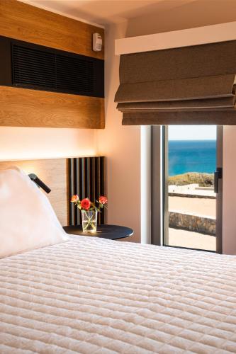 a bedroom with a bed with a view of the ocean at Akre Villas in Ierapetra
