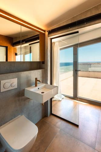 a bathroom with a sink and a toilet at Akre Villas in Ierapetra