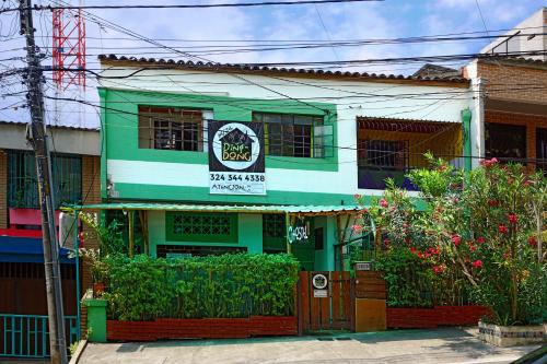 a green and white building with a sign on it at Ding-Dong Hostel in Cali