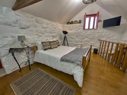 a bedroom with a bed and a staircase with a window at Quinta da Peça Douro Wine Region Retreat, Private Pool Villa in Vila Real