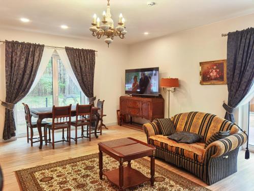 a living room with a couch and a table at Vila Omama in Palanga