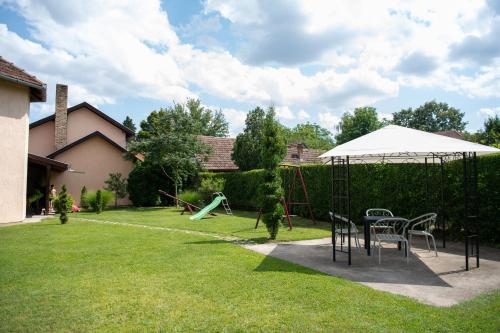 a playground with a table and chairs in a yard at Guesthouse Kristina in Palić