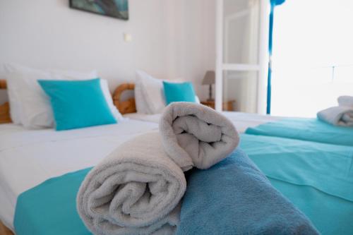 a towel is sitting on top of a bed at Elounda Residence Resort & Waterpark in Elounda