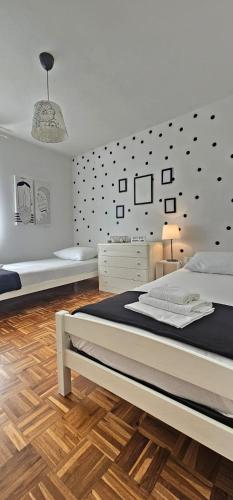 a bedroom with a bed and a wall with polka dots at LUKA APARTMENT in Posedarje