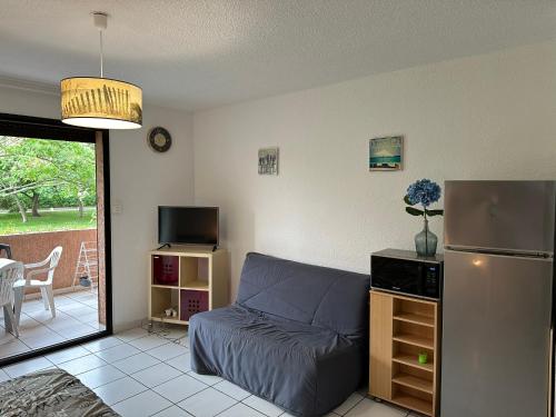 ein Wohnzimmer mit Couch und Kühlschrank in der Unterkunft Les Marines in San-Nicolao
