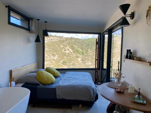 a bedroom with a bed and a large window at Metafort in Méthamis