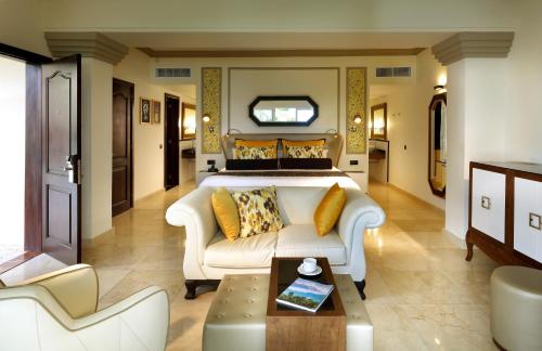 a large bedroom with a bed and a couch at The Signature Level at Grand Palladium Lady Hamilton Resort & Spa- All Inclusive in Lucea