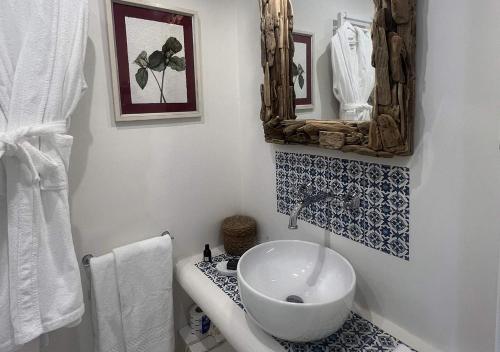 a bathroom with a sink and a mirror at Il Palazzetto Ponza in Ponza