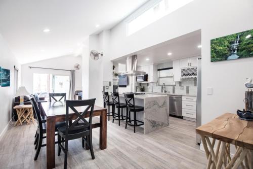 a kitchen and dining room with a table and chairs at 3 Bedrooms in Newport Beach