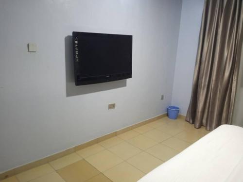 a flat screen tv on a wall in a room at Morada Hotels Ltd in Lagos