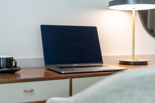 a laptop computer sitting on top of a desk at hirschen dornbirn - das boutiquestyle hotel - skyrelax & wellness im rooftop in Dornbirn