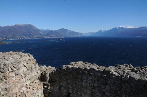 a large body of water with mountains in the background at Villa Artemia in Manerba del Garda