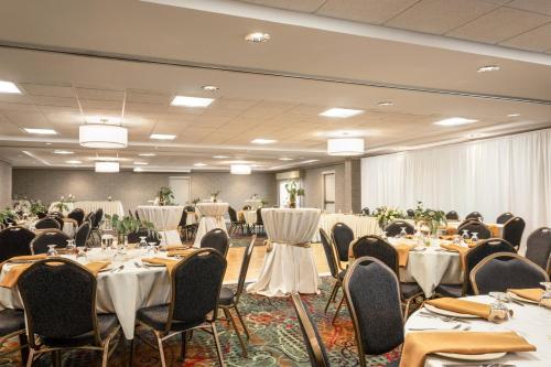 a banquet hall with tables and chairs and tablesearcher at Holiday Inn Hotel & Suites Council Bluffs by IHG in Council Bluffs