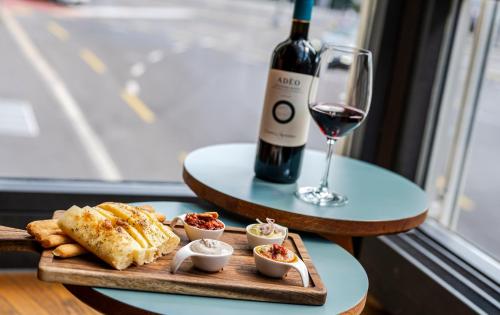 a plate of food and a glass of wine on a table at Hotel Rebstock in Luzern
