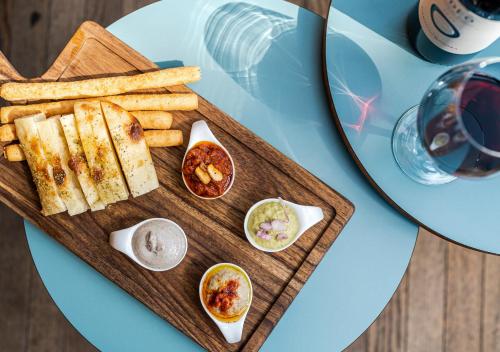 a plate of food with bread and dips on a table at Hotel Rebstock in Luzern