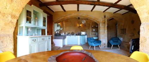 a kitchen and dining room with a table and chairs at La Cava - Palazzo Pallotti in Bagnoregio