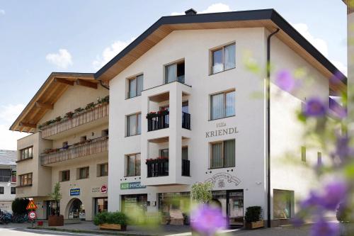 a large white building with flowers in front of it at Kriendl Nr 4 in Valdaora