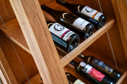 a bunch of wine bottles in a wooden cabinet at Hotel Rebstock in Luzern
