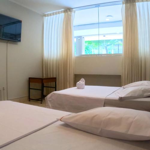 a hotel room with two beds and a window at Royal Park Hotel in Pucallpa