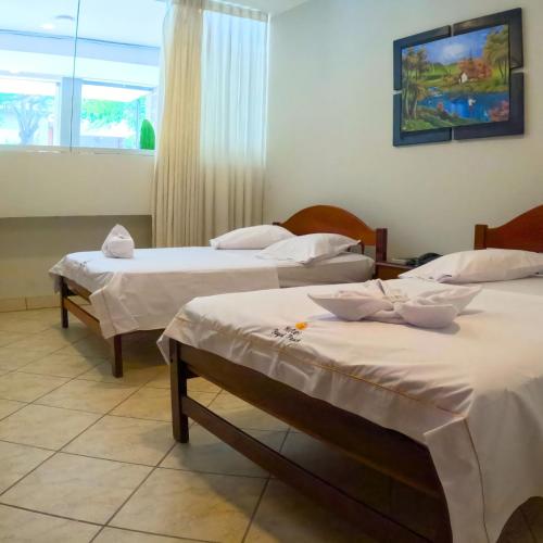 a room with two beds and a window at Royal Park Hotel in Pucallpa