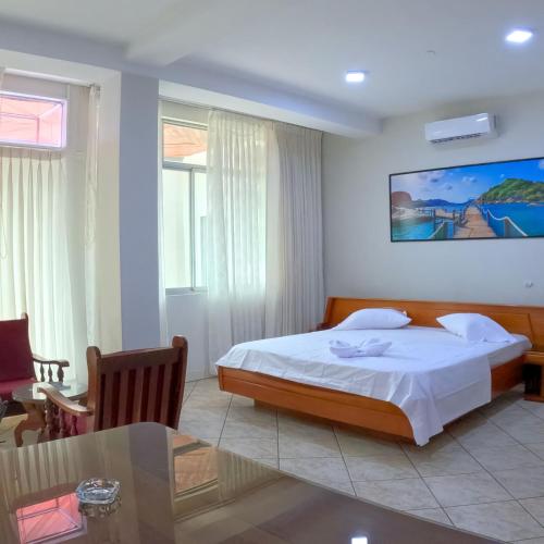 a hotel room with a bed and a table at Royal Park Hotel in Pucallpa