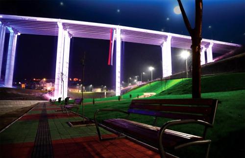 a row of benches in a park at night at Apartmani Vrla NEW in Vladičin Han