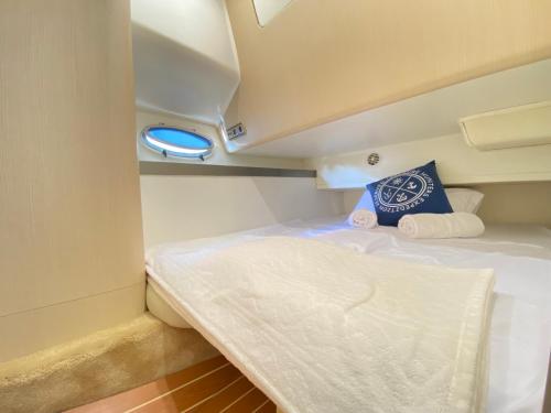 a small bed in a small room on a boat at The Valencia Yacht Experience in Valencia