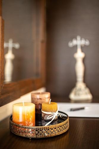 a tray with candles sitting on a table at Vintage Suites Trikala in Tríkala