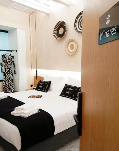 a bedroom with a bed and a sign on the wall at Domus Vivendi in Chania Town