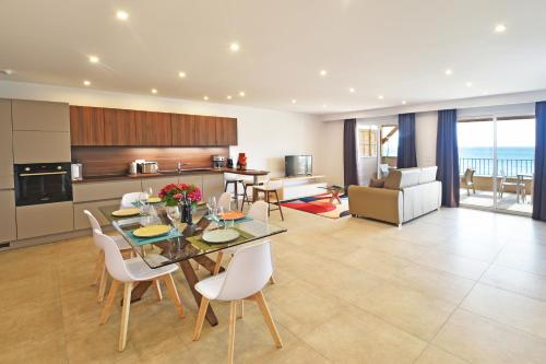 a kitchen and living room with a table and chairs at Résidence Saint-Jean in Saint-Florent