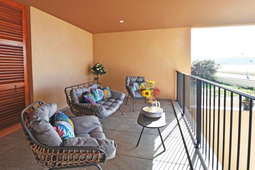 a balcony with two chairs and a table on a balcony at Résidence Saint-Jean in Saint-Florent