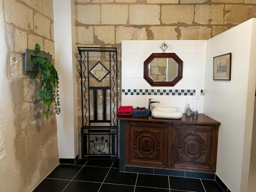 a bathroom with a sink and a mirror at Beaulieu La Source in Saumur