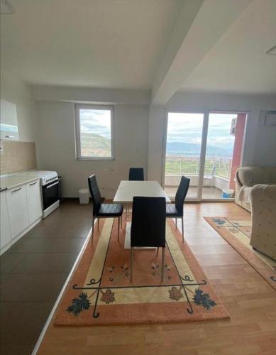a kitchen and dining room with a table and chairs at Skopje City View Condominium in Skopje