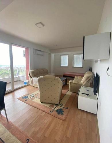 a living room with couches and a flat screen tv at Skopje City View Condominium in Skopje