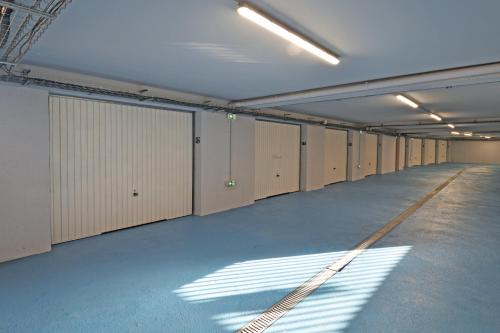 a row of lockers in a large room with sunlight at Résidence Saint-Jean in Saint-Florent
