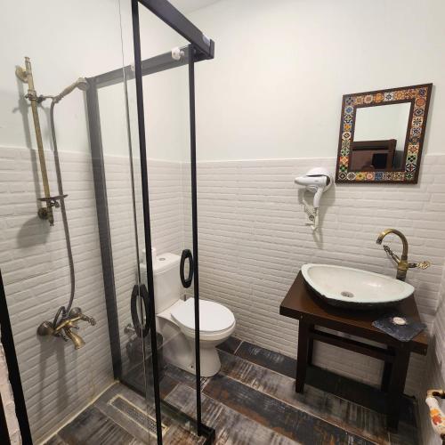 a bathroom with a toilet and a sink at Kapela Taş Otel Alaçatı in Çeşme