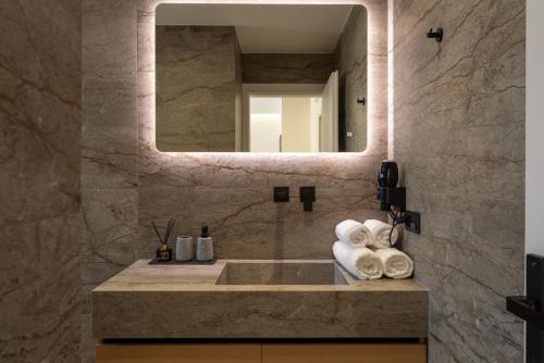 a bathroom with a sink and a mirror at Irisma Luxury Villa with private pool in Archanes